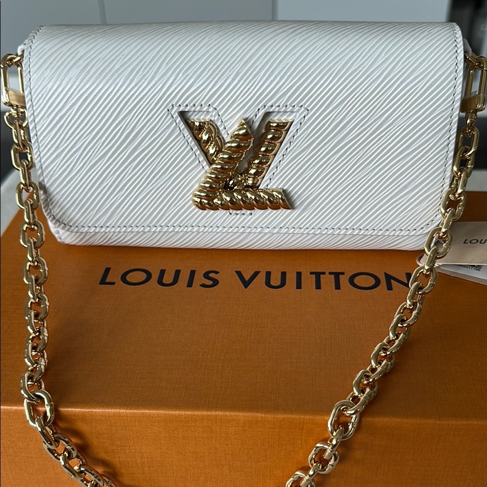 Authentic Louis Vuitton Twist West EPI in white with gold metal, 2 straps